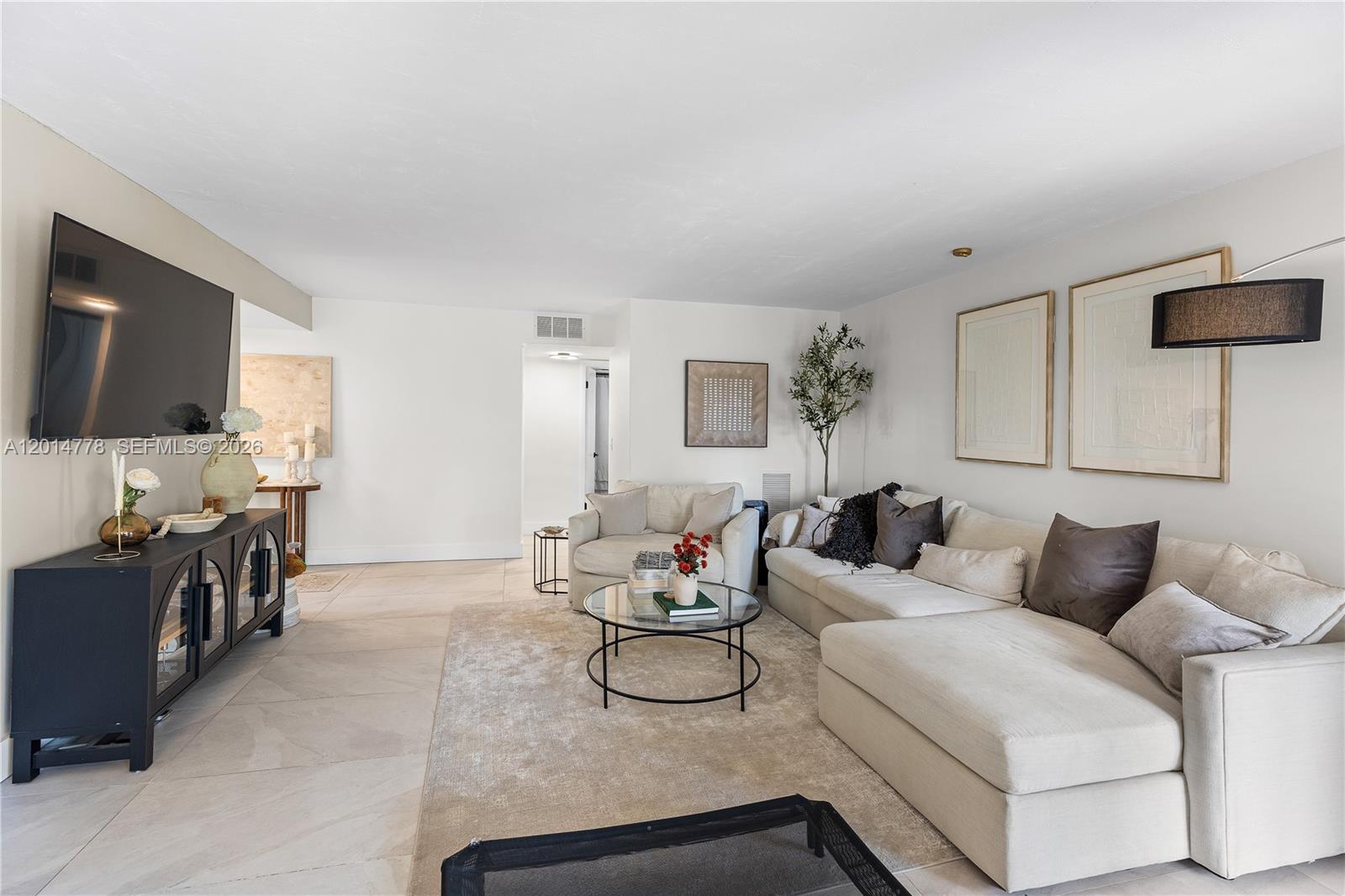5850 Camino Del Sol, Unit 404 Boca Raton, FL 33433 - Photo 11 of 47 a living room with furniture and a flat screen tv