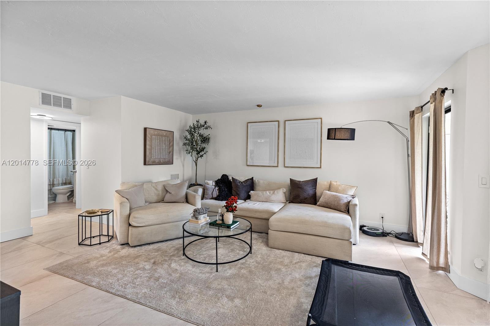 5850 Camino Del Sol, Unit 404 Boca Raton, FL 33433 - Photo 13 of 47 a living room with furniture and a large window