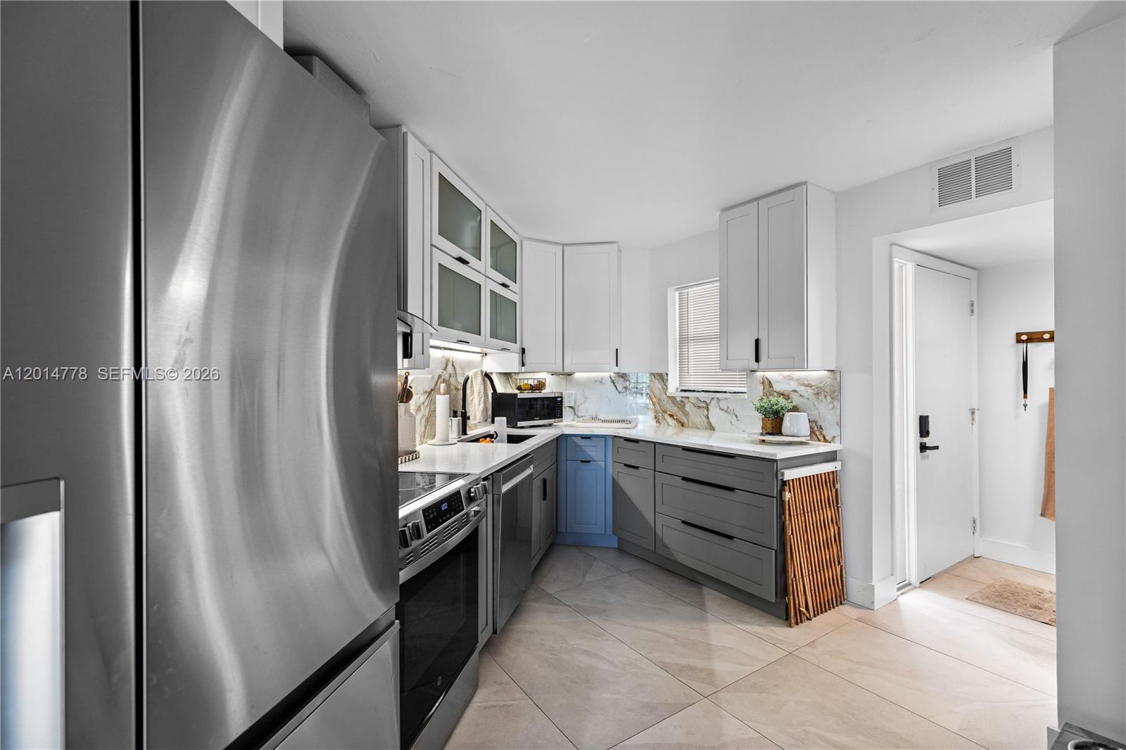 5850 Camino Del Sol, Unit 404 Boca Raton, FL 33433 - Photo 14 of 47 a kitchen with stainless steel appliances granite countertop a refrigerator and a stove top oven