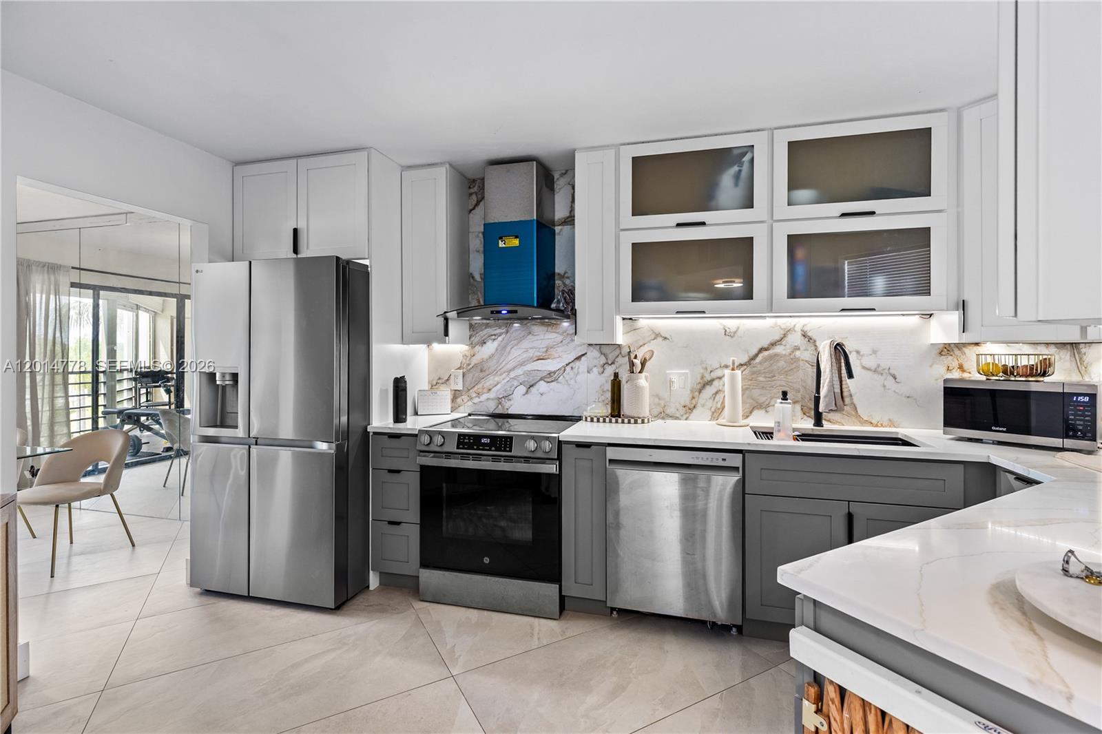 5850 Camino Del Sol, Unit 404 Boca Raton, FL 33433 - Photo 15 of 47 a kitchen with stainless steel appliances granite countertop a refrigerator and a sink