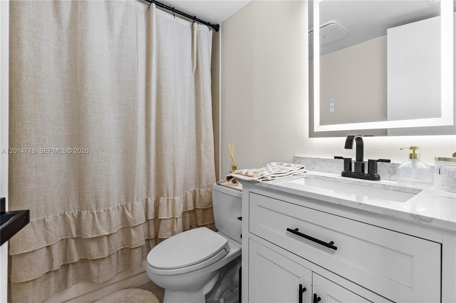 5850 Camino Del Sol, Unit 404 Boca Raton, FL 33433 - Photo 19 of 47 a bathroom with a granite countertop sink and a mirror
