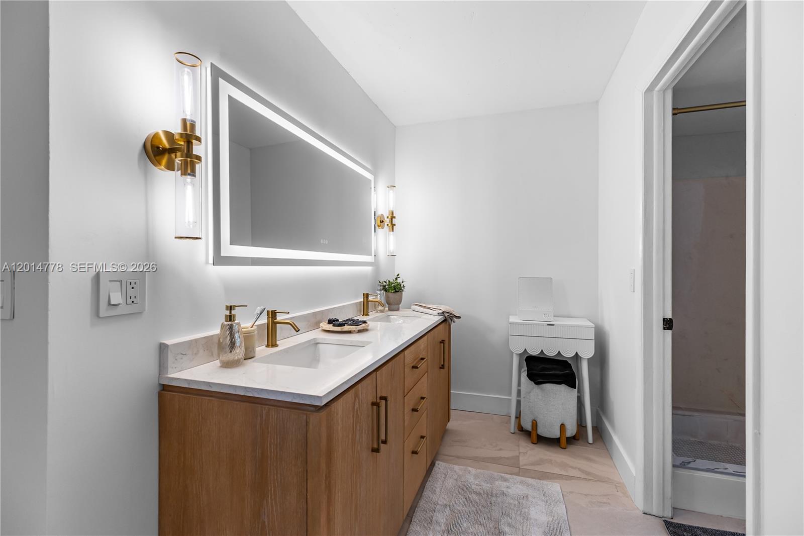 5850 Camino Del Sol, Unit 404 Boca Raton, FL 33433 - Photo 22 of 47 a bathroom with a sink vanity and mirror