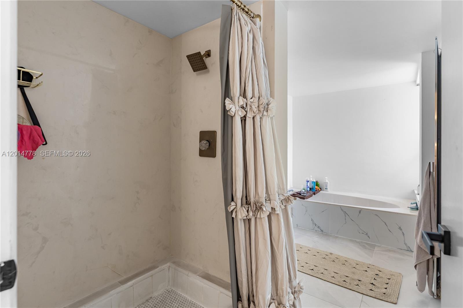 5850 Camino Del Sol, Unit 404 Boca Raton, FL 33433 - Photo 24 of 47 a view of a bathroom with a tub and shower