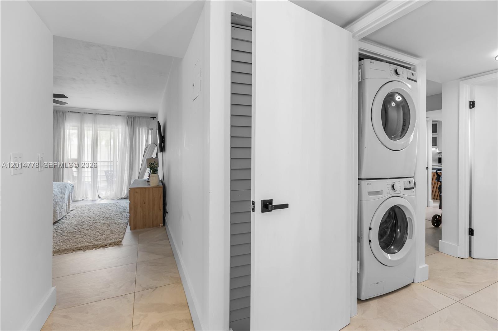 5850 Camino Del Sol, Unit 404 Boca Raton, FL 33433 - Photo 26 of 47 a view of a hallway with washer and dryer
