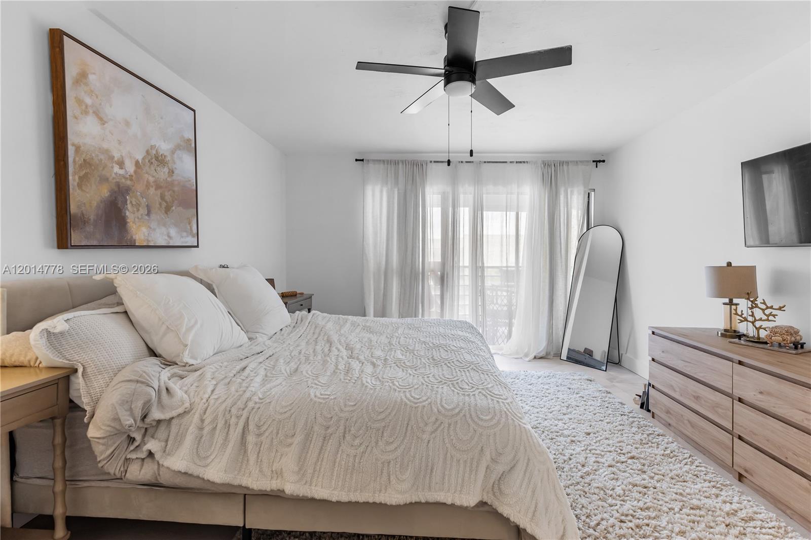 5850 Camino Del Sol, Unit 404 Boca Raton, FL 33433 - Photo 28 of 47 a bedroom with a bed and a chandelier