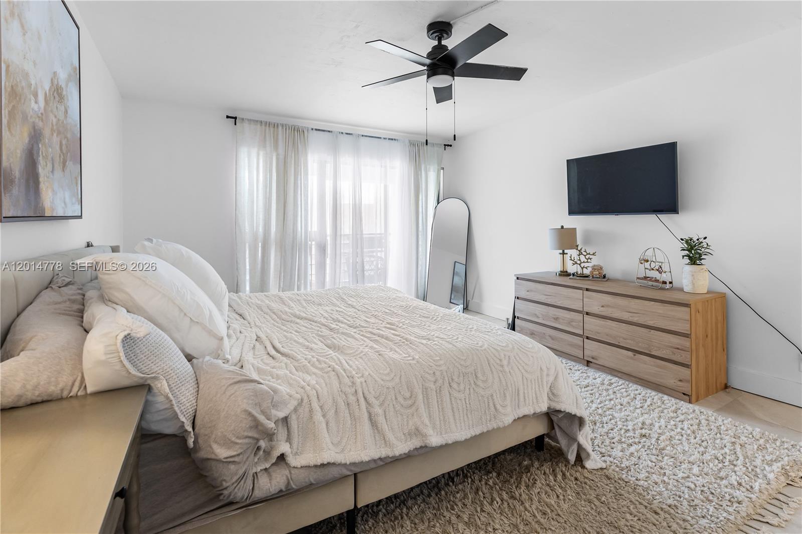 5850 Camino Del Sol, Unit 404 Boca Raton, FL 33433 - Photo 30 of 47 a bedroom with a bed tv and a window
