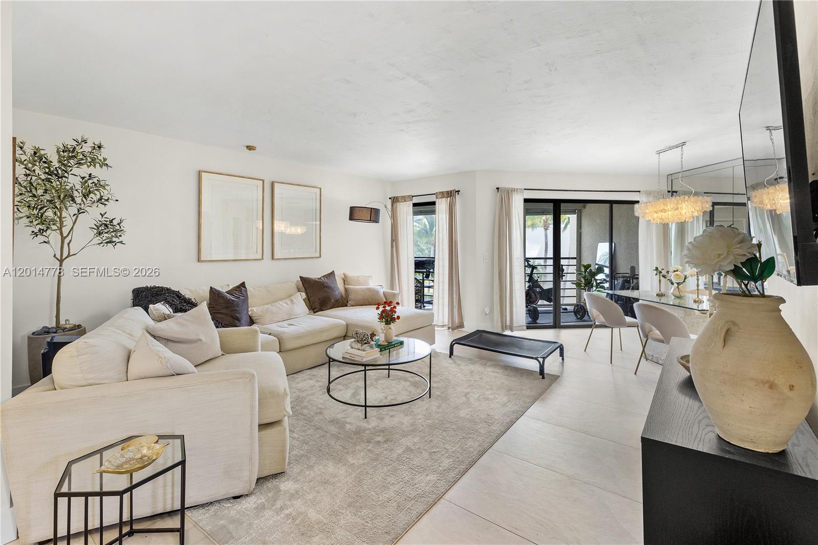 5850 Camino Del Sol, Unit 404 Boca Raton, FL 33433 - Photo 3 of 47 a living room with furniture and a large window