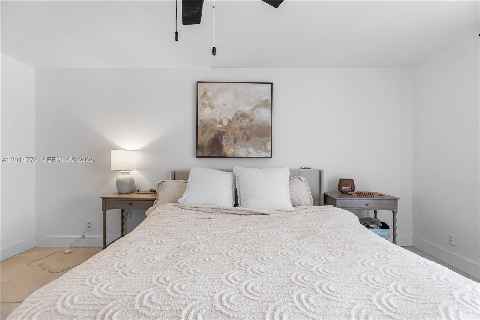 5850 Camino Del Sol, Unit 404 Boca Raton, FL 33433 - Photo 31 of 47 a bedroom with a bed and a painting on the wall