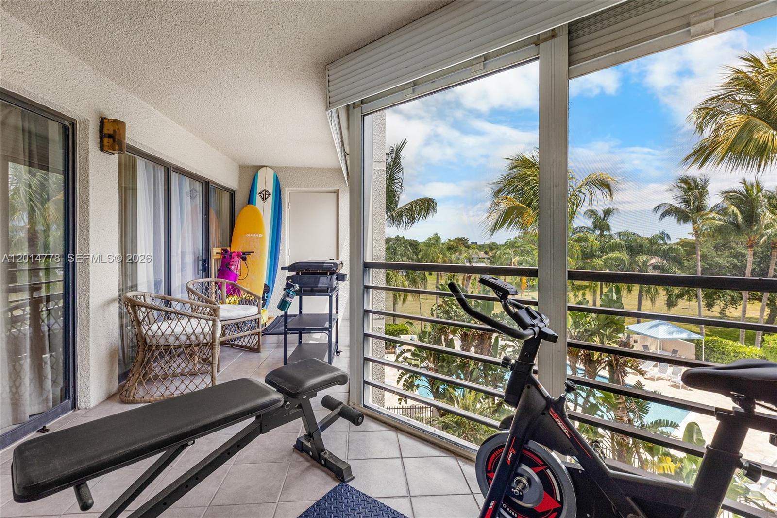 5850 Camino Del Sol, Unit 404 Boca Raton, FL 33433 - Photo 33 of 47 a view of a balcony with chairs and wooden floor