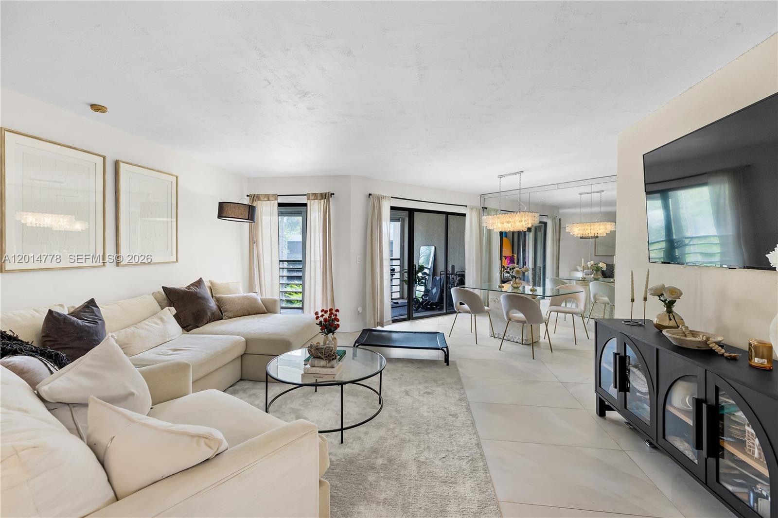 5850 Camino Del Sol, Unit 404 Boca Raton, FL 33433 - Photo 4 of 47 a living room with furniture and a large window