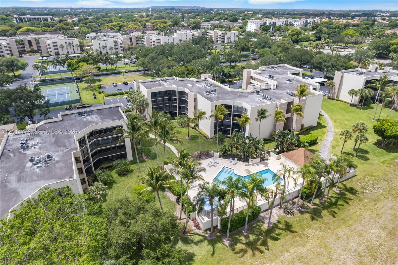 5850 Camino Del Sol, Unit 404 Boca Raton, FL 33433 - Photo 42 of 47 an aerial view of a house with a yard garage and lake view