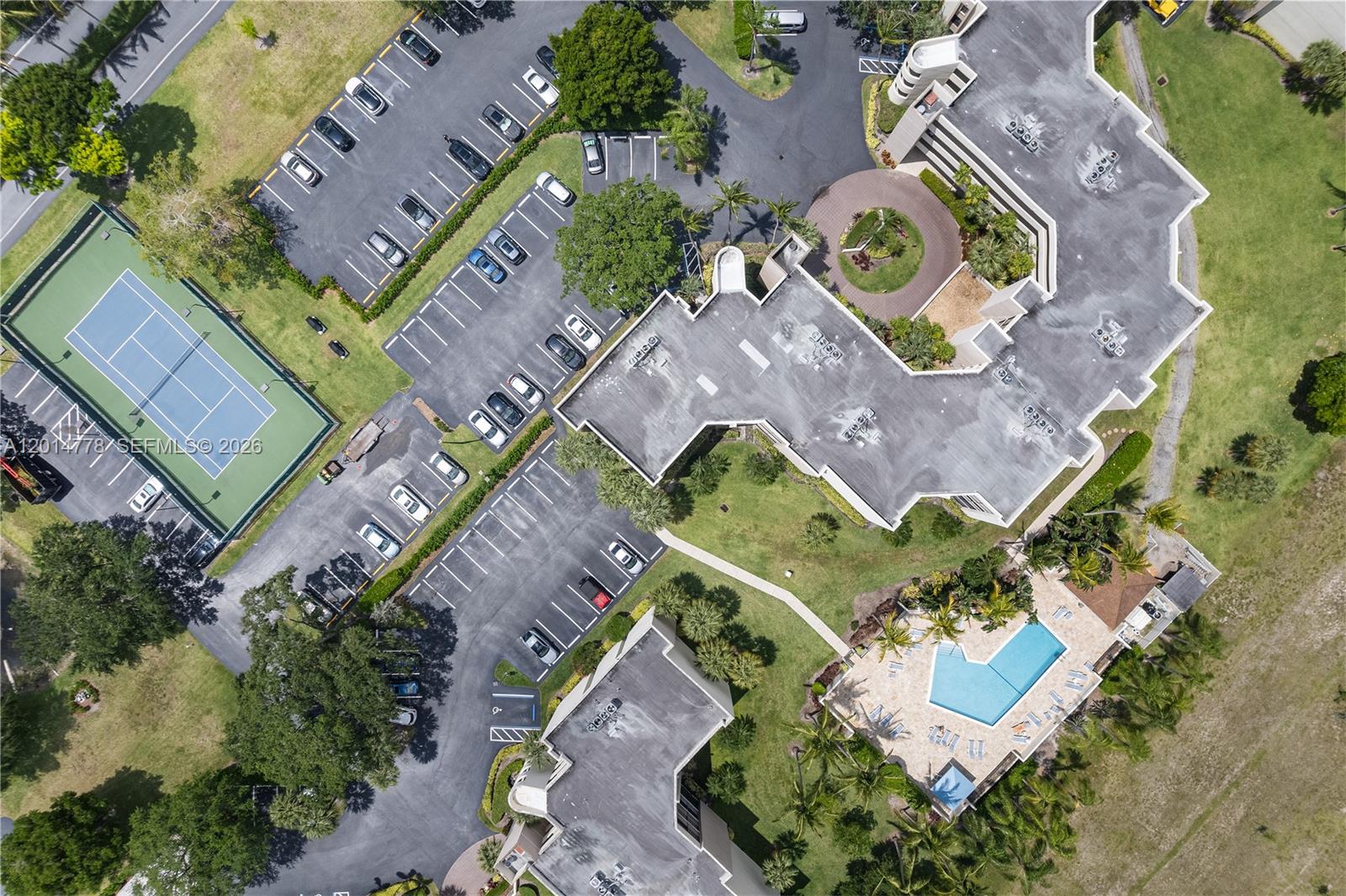 5850 Camino Del Sol, Unit 404 Boca Raton, FL 33433 - Photo 43 of 47 an aerial view of a house with a garden and swimming pool