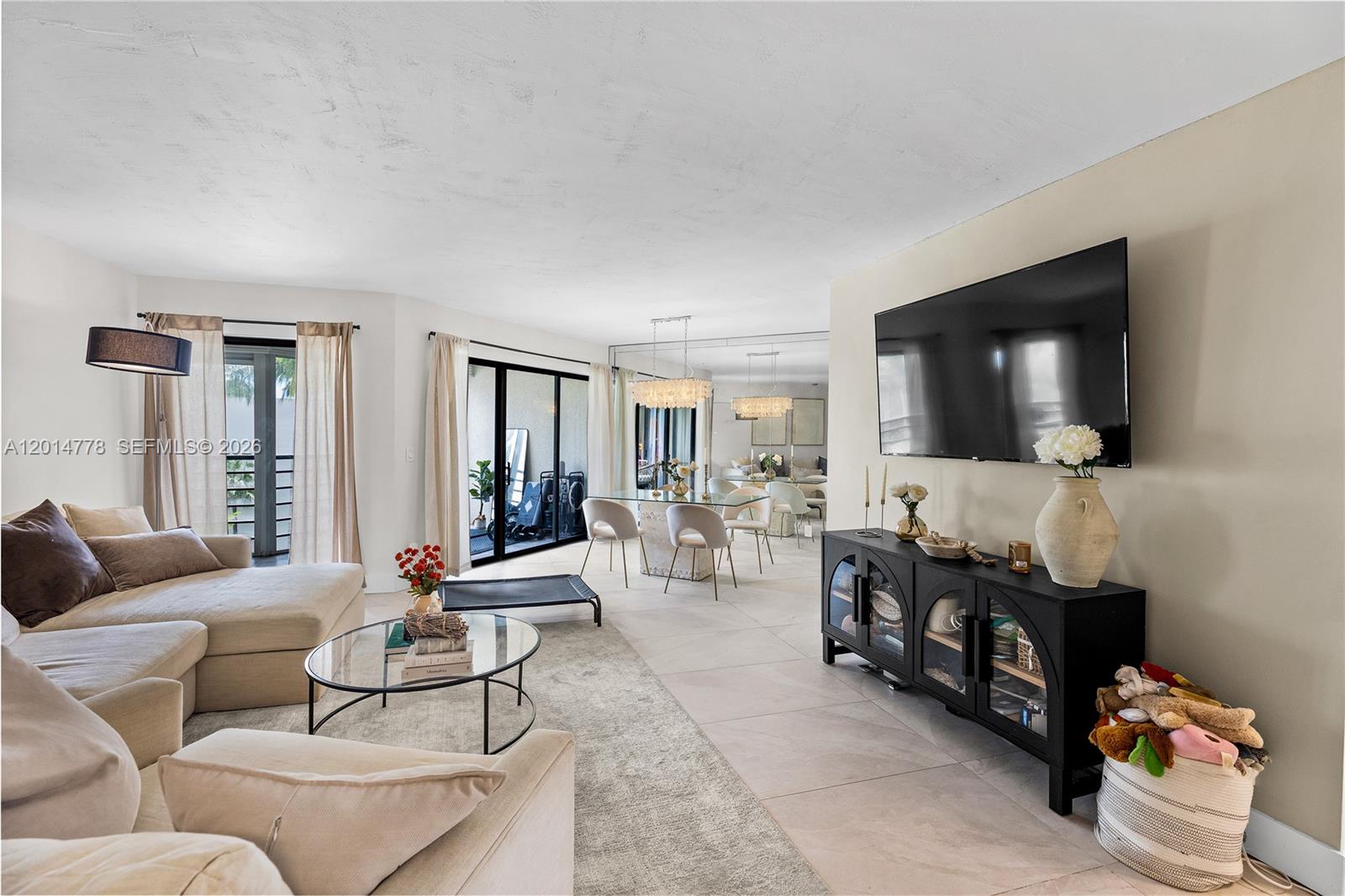 5850 Camino Del Sol, Unit 404 Boca Raton, FL 33433 - Photo 5 of 47 a living room with furniture and a flat screen tv
