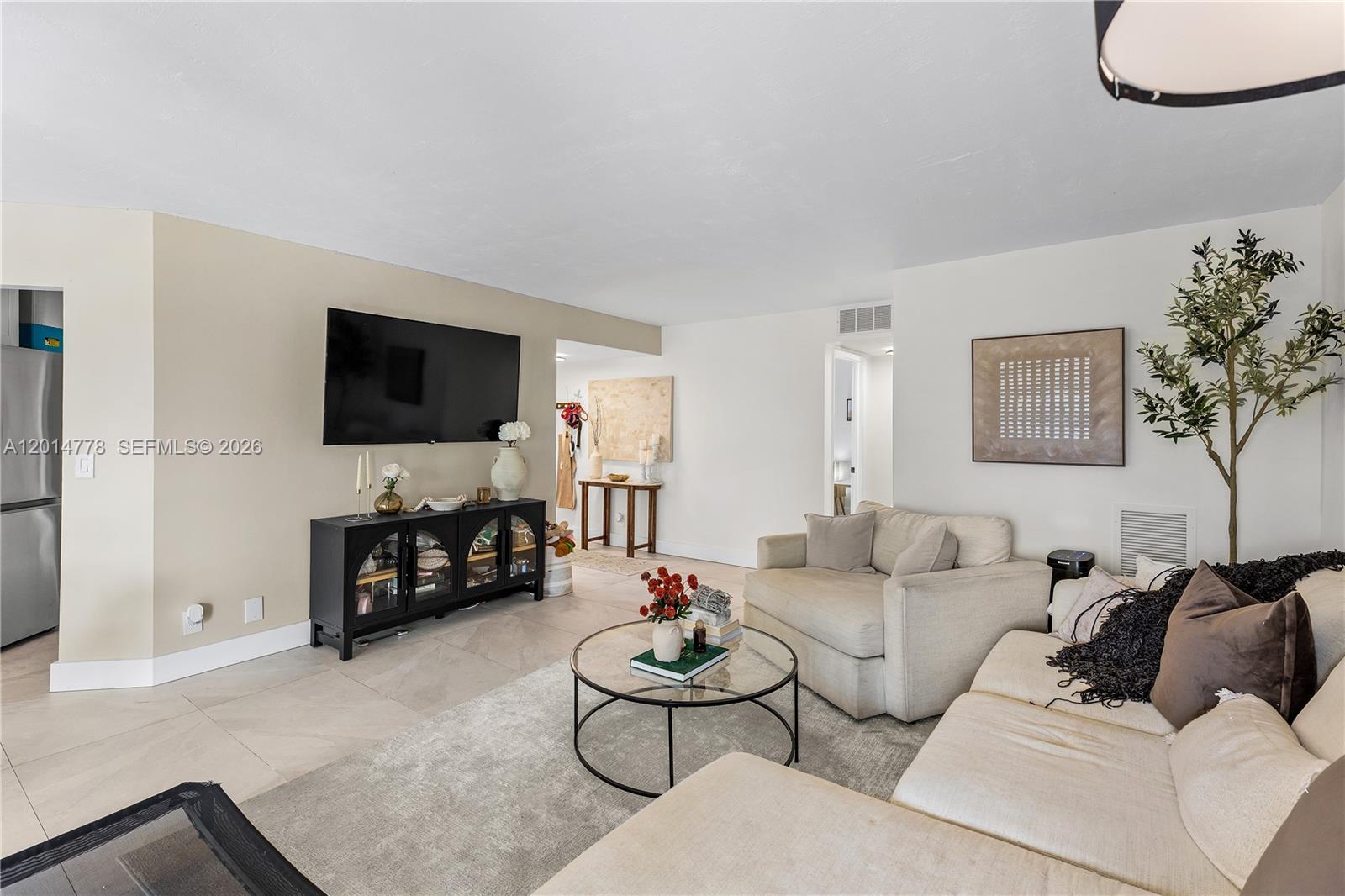 5850 Camino Del Sol, Unit 404 Boca Raton, FL 33433 - Photo 6 of 47 a living room with furniture and a flat screen tv