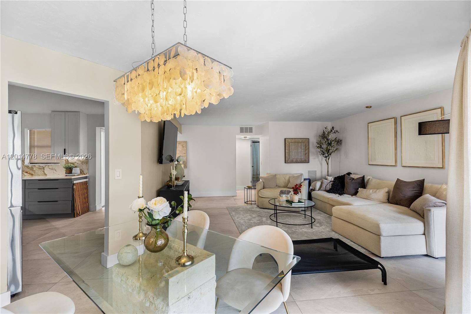 5850 Camino Del Sol, Unit 404 Boca Raton, FL 33433 - Photo 7 of 47 a living room with furniture and a chandelier