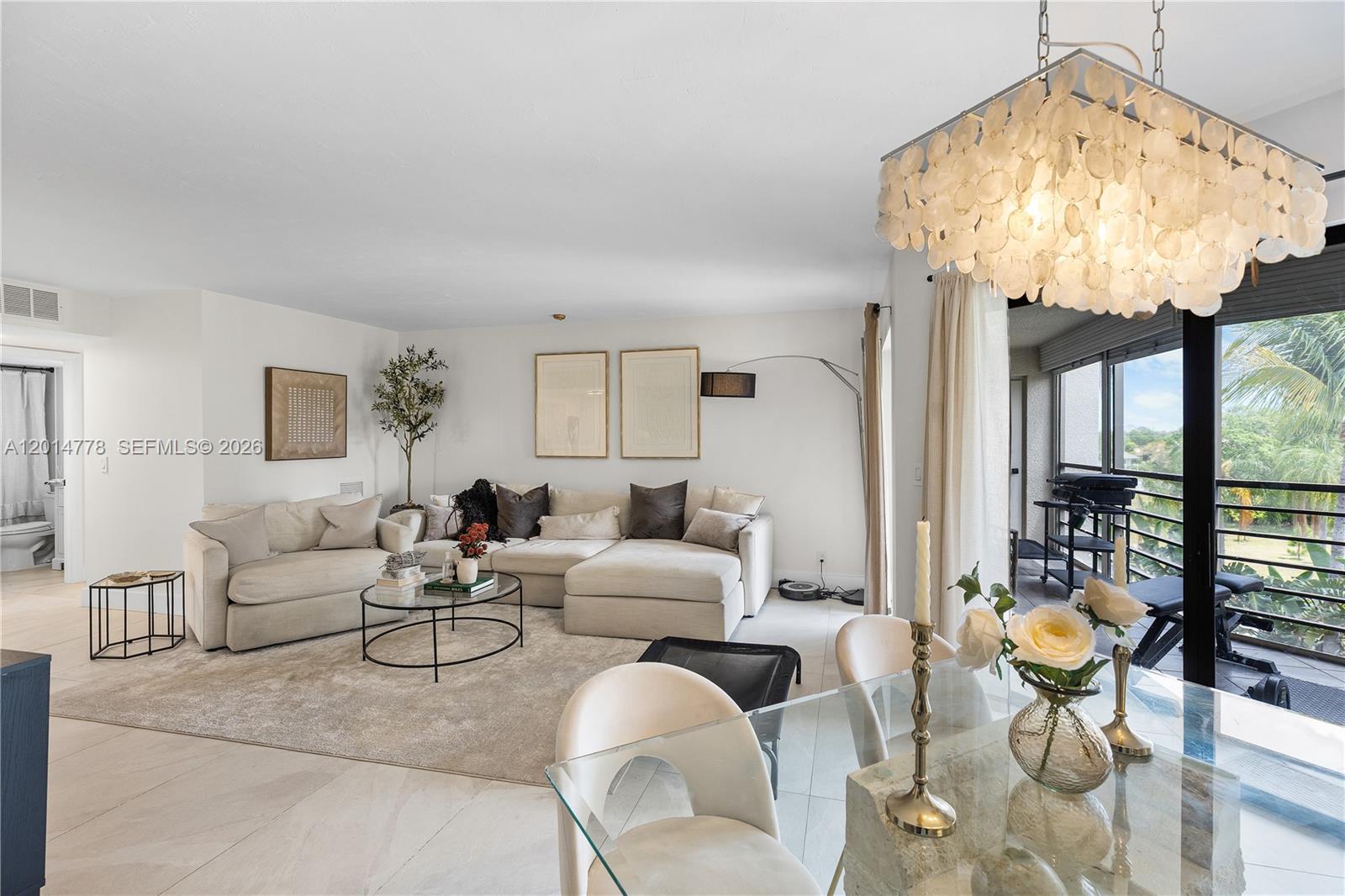 5850 Camino Del Sol, Unit 404 Boca Raton, FL 33433 - Photo 9 of 47 a living room with furniture a chandelier and a chandelier