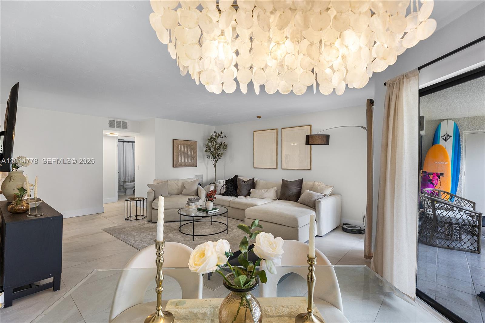 5850 Camino Del Sol, Unit 404 Boca Raton, FL 33433 - Photo 10 of 47 a living room with furniture and a chandelier