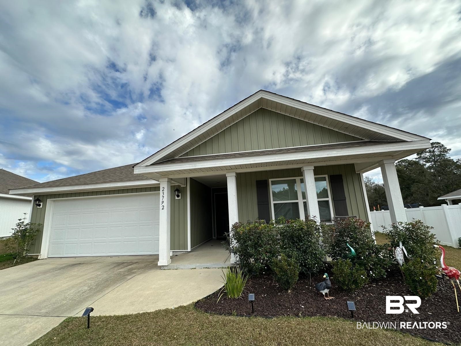 23792 Unbridled Loop Daphne, AL 36526 - Photo 1 of 36 Single story home featuring a porch, driveway, board and batten siding, and a garage