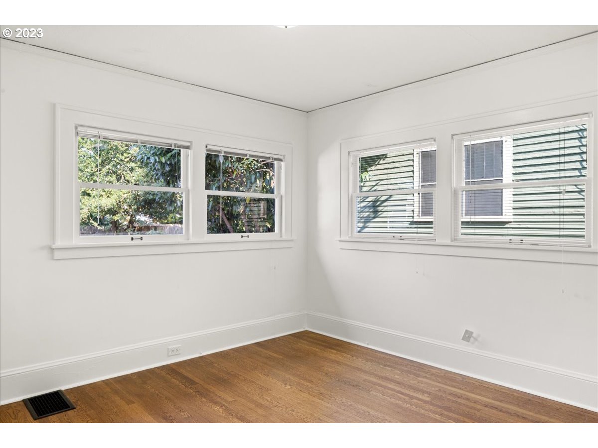 2015 Northeast 38th Avenue Portland, OR 97212 - Photo 20 of 32 a view of an empty room with wooden floor and windows