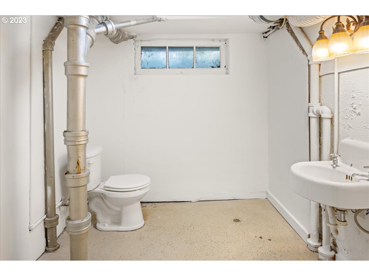 2015 Northeast 38th Avenue Portland, OR 97212 - Photo 26 of 32 a bathroom with a toilet a sink and a mirror