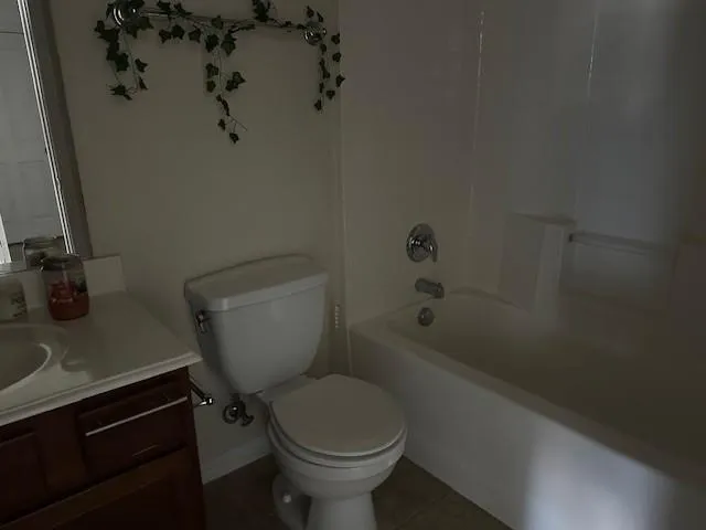 a white toilet sitting next to a bathroom sink