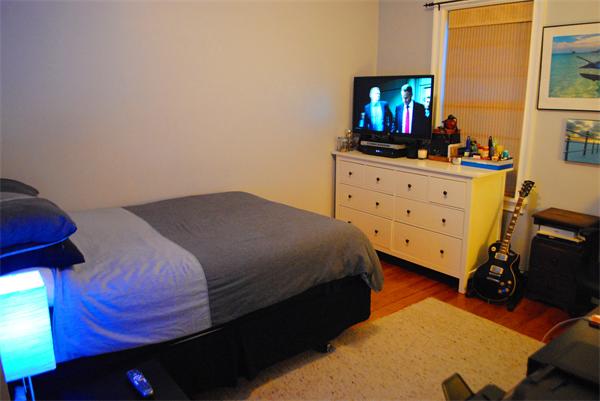 421 East 3rd Street, Unit 2 Boston, MA 02127 - Photo 12 of 25 a bedroom with a bed and a flat tv screen on dresser