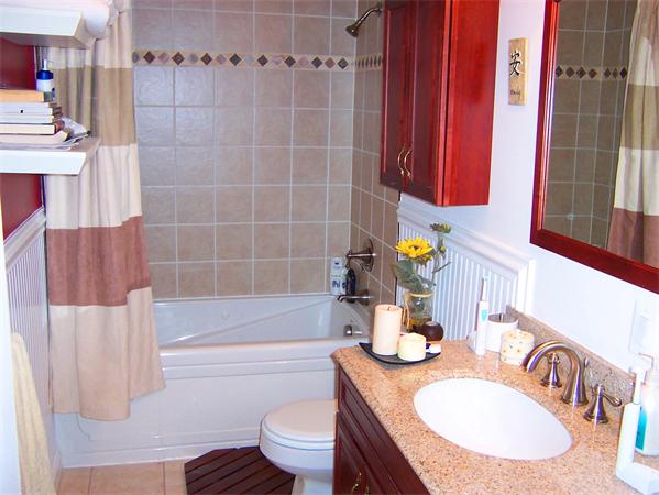 421 East 3rd Street, Unit 2 Boston, MA 02127 - Photo 19 of 25 a bathroom with a granite countertop bathtub sink vanity mirror and toilet