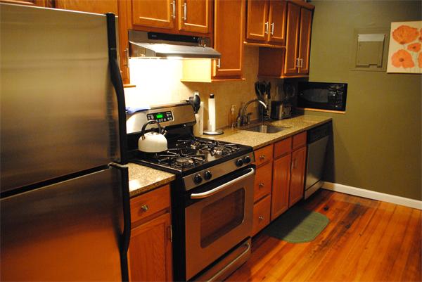 421 East 3rd Street, Unit 2 Boston, MA 02127 - Photo 2 of 25 a kitchen with wooden floor and a stove