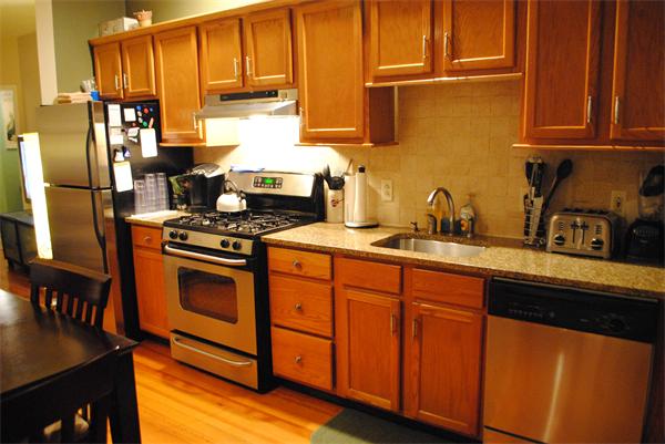 421 East 3rd Street, Unit 2 Boston, MA 02127 - Photo 7 of 25 a kitchen with stainless steel appliances granite countertop a stove a sink dishwasher and a refrigerator