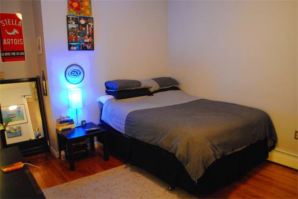 421 East 3rd Street, Unit 2 Boston, MA 02127 - Photo 10 of 25 a bedroom with a bed and a lamp on dresser