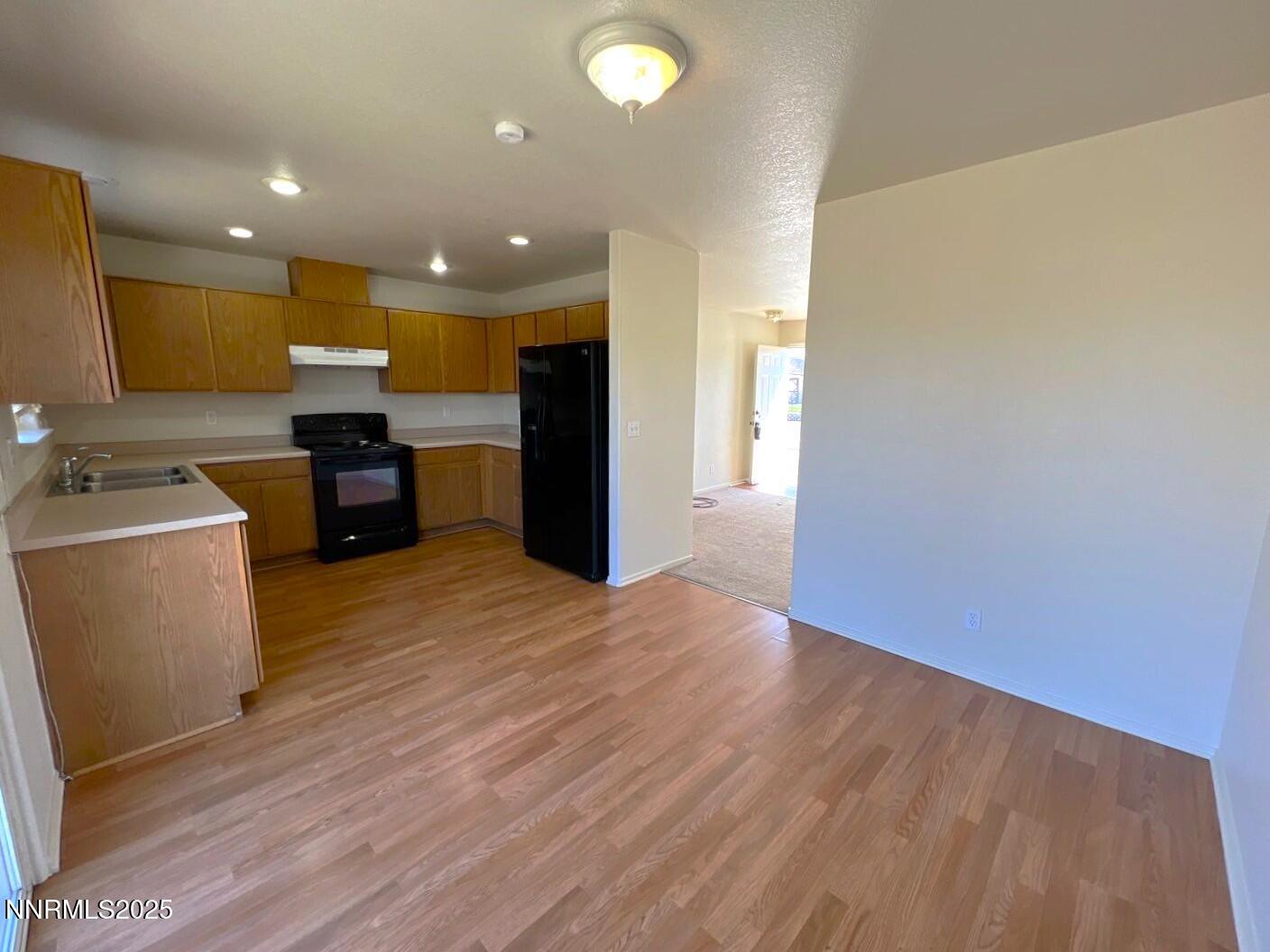 13405 Mt Lassen Street Reno, NV 89506 - Photo 3 of 20 a view of a kitchen with a sink and a refrigerator