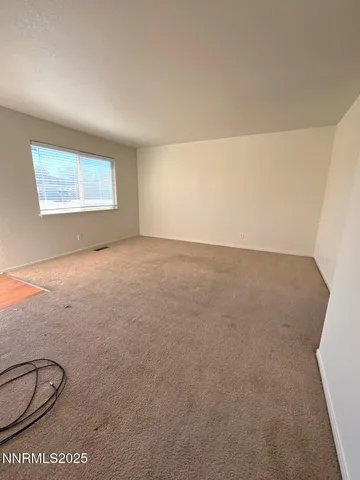 an empty room with a empty space and windows