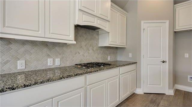 2017 Limestone Lake Drive Georgetown, TX 78633 - Photo 11 of 25 a kitchen with granite countertop white cabinets and a stove