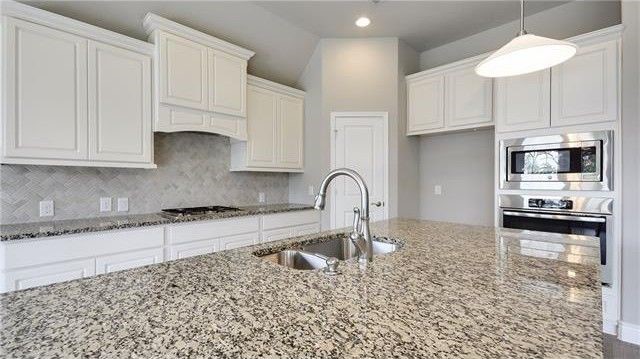 2017 Limestone Lake Drive Georgetown, TX 78633 - Photo 12 of 25 a kitchen with stainless steel appliances granite countertop a stove a sink and a white cabinets