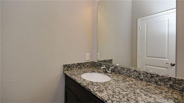 2017 Limestone Lake Drive Georgetown, TX 78633 - Photo 20 of 25 a bathroom with a granite countertop sink and a mirror