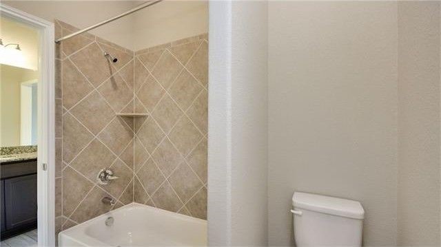 2017 Limestone Lake Drive Georgetown, TX 78633 - Photo 21 of 25 a bathroom with a shower and toilet
