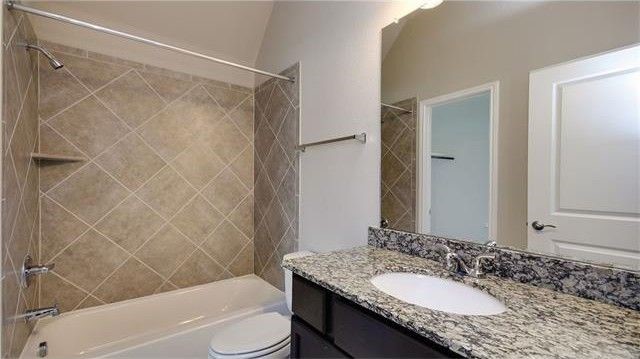 2017 Limestone Lake Drive Georgetown, TX 78633 - Photo 24 of 25 a bathroom with a granite countertop sink toilet and shower