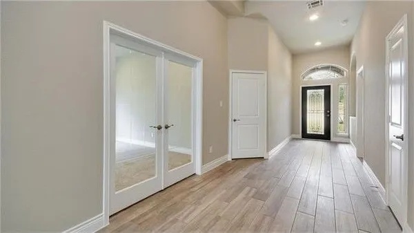 a view of kitchen with refrigerator and window