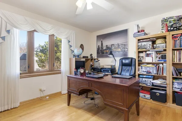 a view of a workspace with furniture and a window