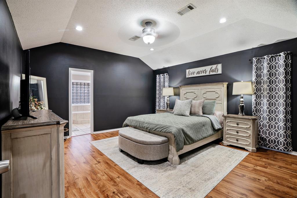 575 Mansfield Road Reno, TX 75462 - Photo 12 of 23 a bedroom with a bed and a chandelier