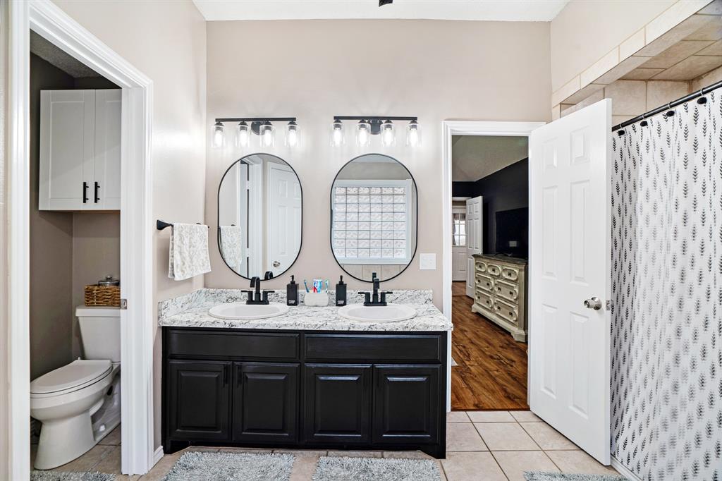 575 Mansfield Road Reno, TX 75462 - Photo 14 of 23 a bathroom with a double vanity sink and a mirror