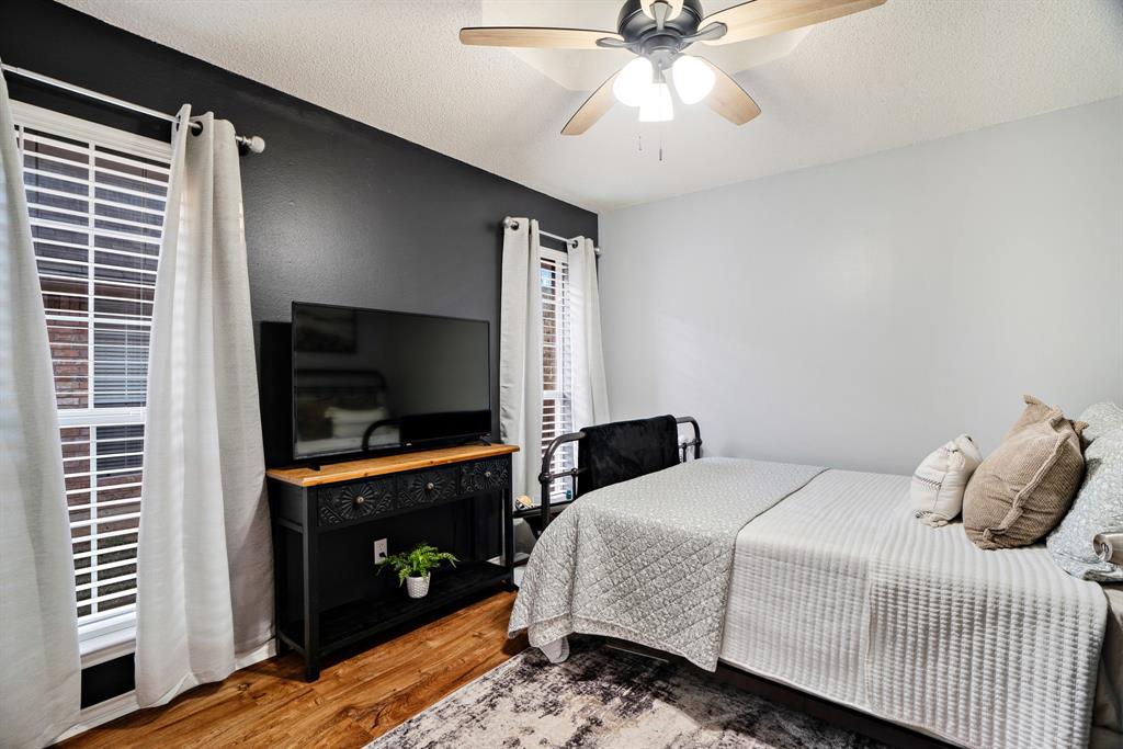 575 Mansfield Road Reno, TX 75462 - Photo 17 of 23 a bedroom with a bed and a flat screen tv