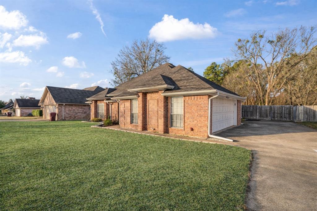 575 Mansfield Road Reno, TX 75462 - Photo 4 of 23 a front view of a house with a garden and yard