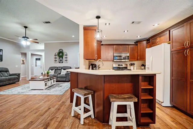 a kitchen with stainless steel appliances granite countertop a sink stove and refrigerator