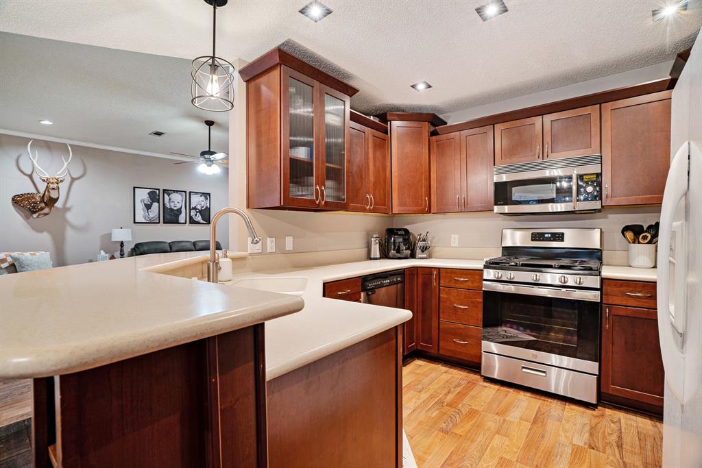 575 Mansfield Road Reno, TX 75462 - Photo 9 of 23 a kitchen with stainless steel appliances granite countertop a sink stove and refrigerator