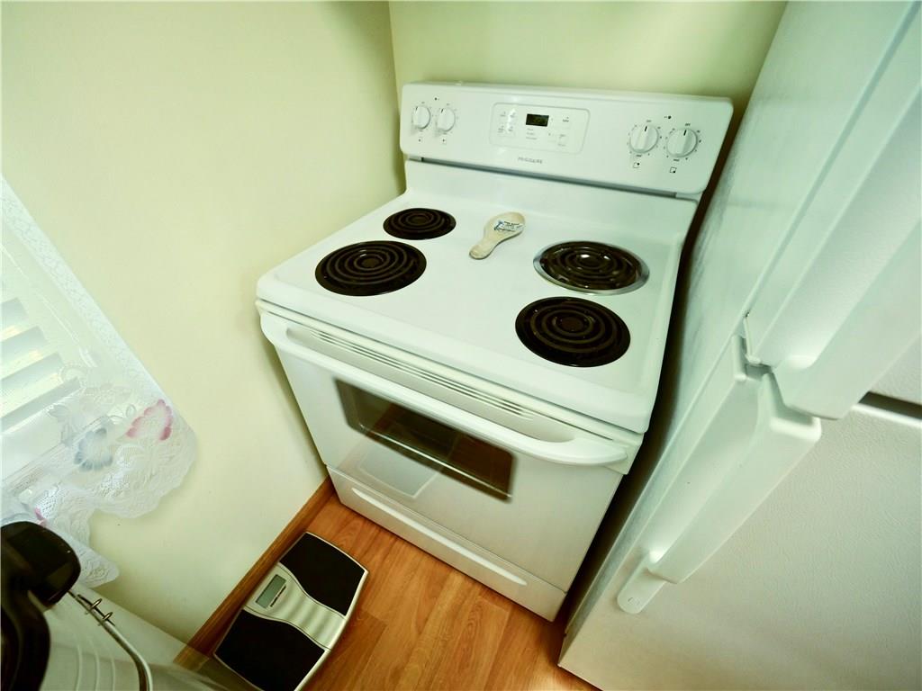219 Pinchtown Road Pittsburgh, PA 15236 - Photo 16 of 25 Kitchen is Equipped with an Electric Stove, Fridge and Microwave, everything you need.