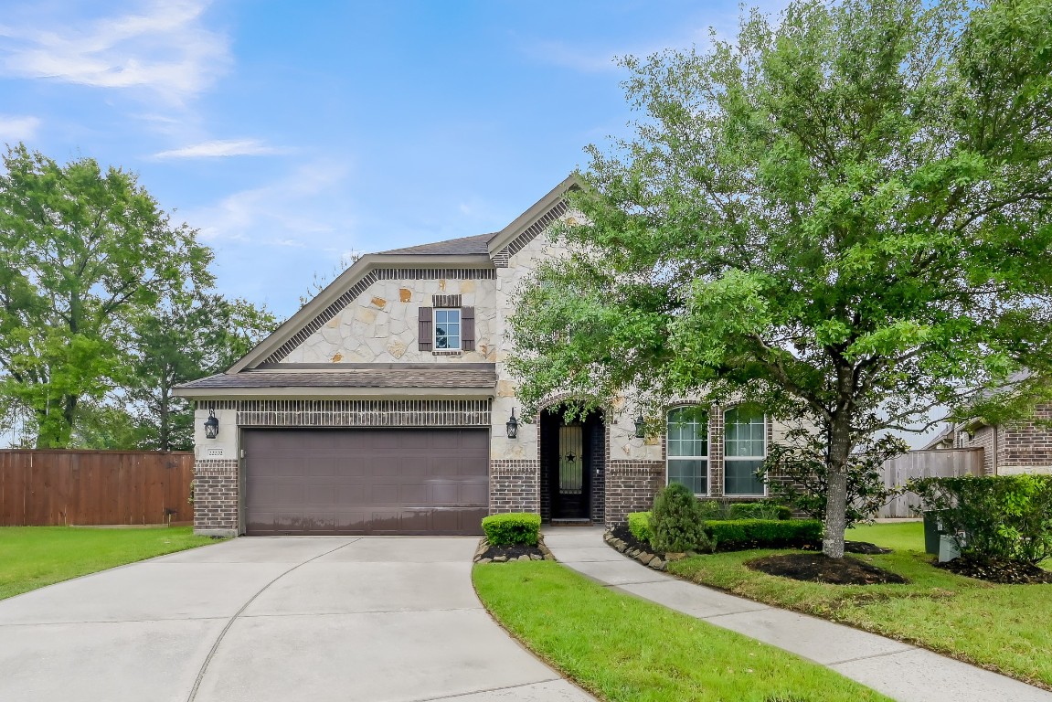 22202 Weller Oaks Drive Spring, TX 77389 - Photo 1 of 39 front view of a house with a garden
