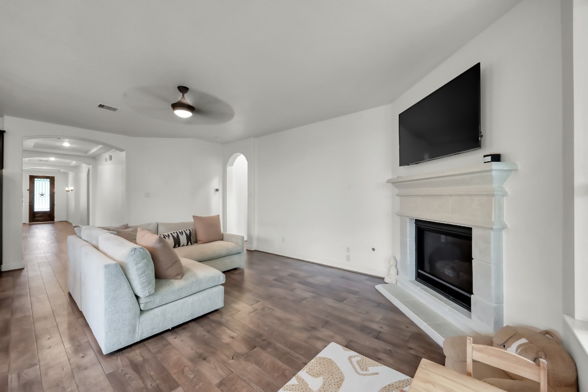 22202 Weller Oaks Drive Spring, TX 77389 - Photo 16 of 39 a living room with furniture a fireplace and a flat screen tv
