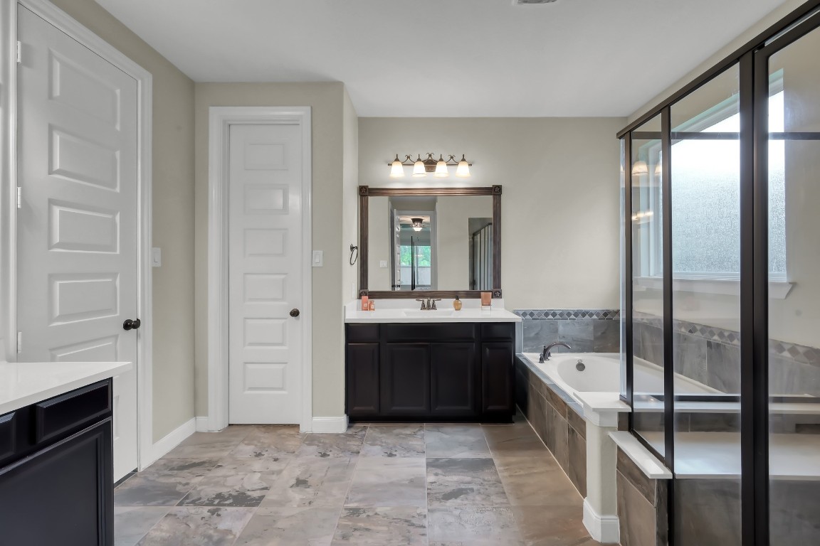 22202 Weller Oaks Drive Spring, TX 77389 - Photo 19 of 39 a spacious bathroom with a tub and shower