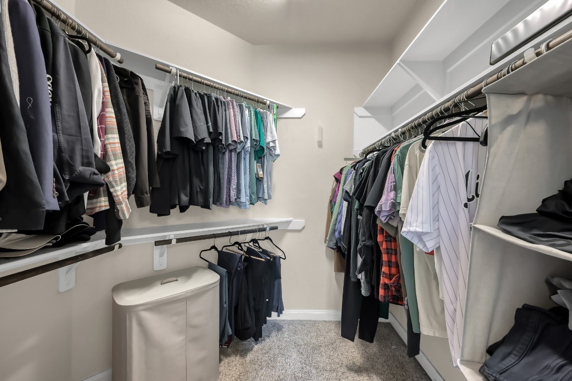 22202 Weller Oaks Drive Spring, TX 77389 - Photo 22 of 39 a view of walk in closet with clothes and shoes